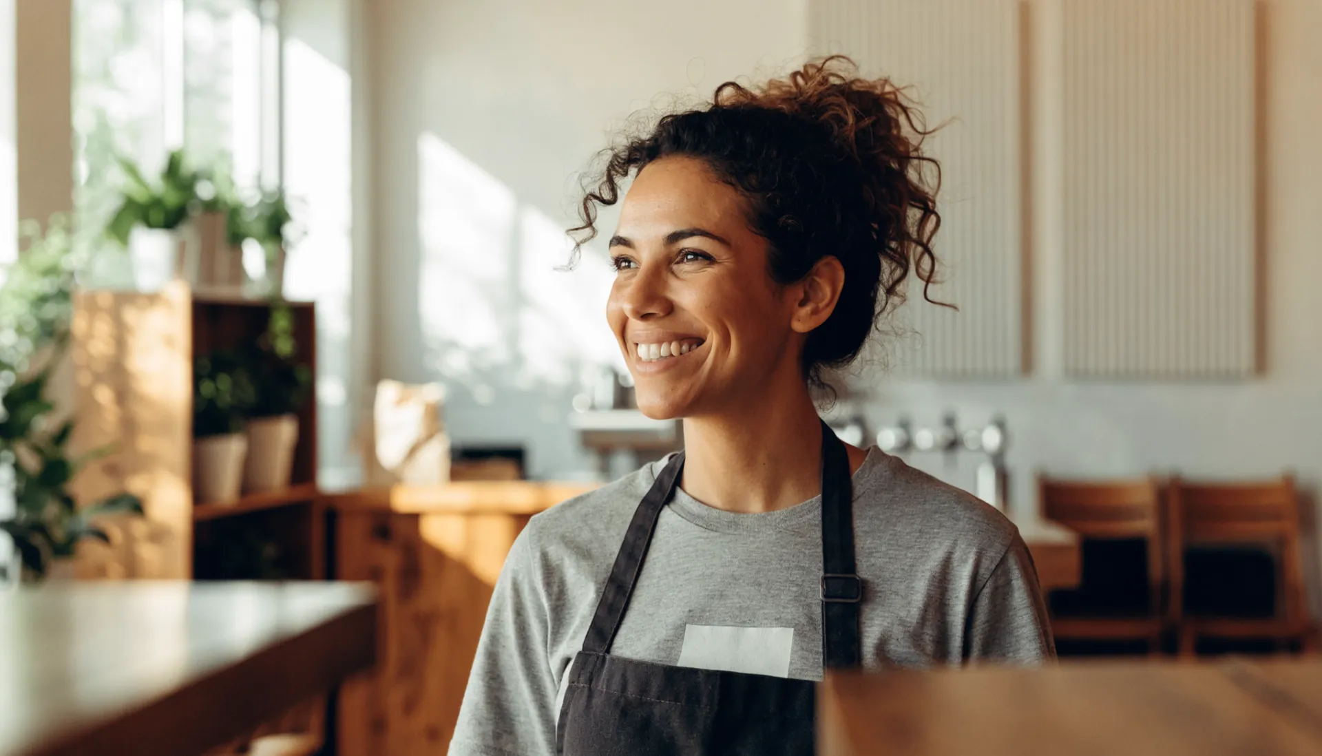 A coffee shop owner wearing her shop's shirt